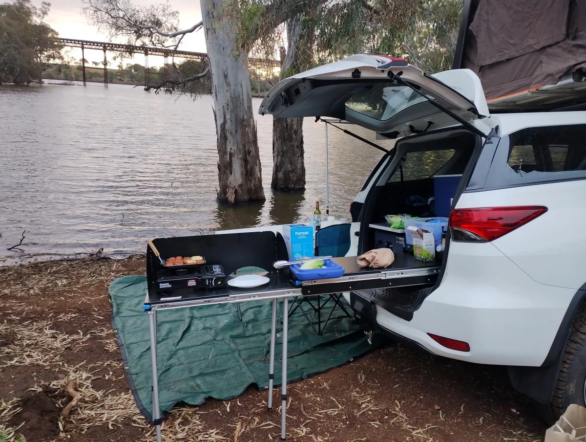 Leopardo’s rooftop tent and camping kitchen beside the river